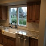 Cabinets with new granite and farmhouse sink