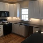 Renovated kitchen with new cabinets,  quartz countertop and paint