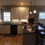 Renovated kitchen with new cabinets,  quartz countertop, backsplash tile and paint